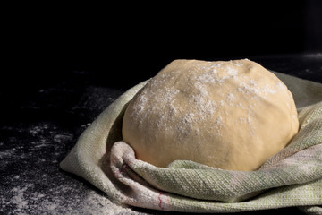 Homemade dough for pizza on a napkin. Home-made rustic pastries, pizza making process