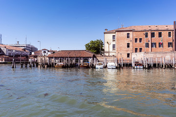 Venice, Veneto / Italy- May 20, 2017: Industrial buildings on the canal to the sea of venice