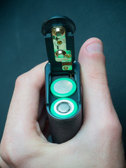 put a 18650 battery in an electronic cigarette. Li-ion battery in the battery compartment of the...