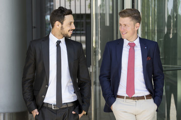 two businessmen greeting each other outside