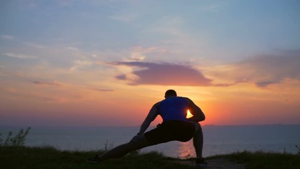Silhouette young strong man stretch SIDE LUNGE workout outdoor dawn slow motion
