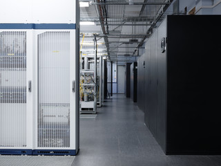 Telecommunication equipment with many cables, switches and air conditioners in a modern communications center