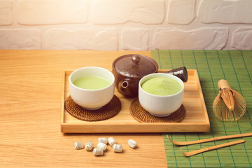 Matcha green organic tea cup and powder on wooden table