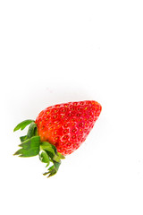 One fresh red strawberry isolated on white 