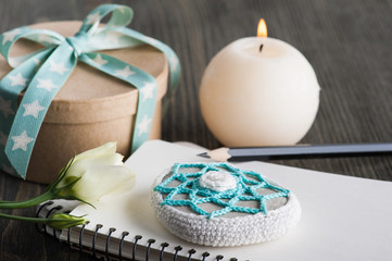 Gift box with star ribbon on dark rustic table