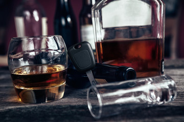 Car key on glass with whisky