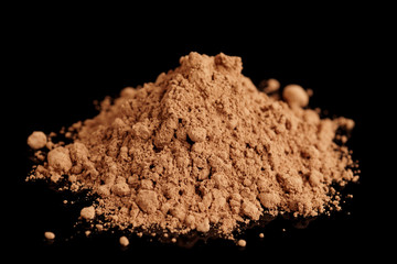 Fototapeta na wymiar Organic cocoa powder isolated on black background