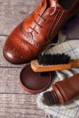 Shoe wax and brushes on wooden surface