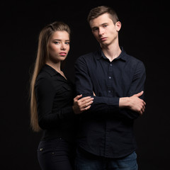 Young happy couple showing presentation pointing on placard over