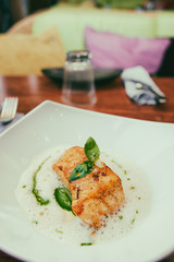 Fried fish fillet with broth sauce, toned