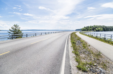 Beautiful road next to lake in Finland
