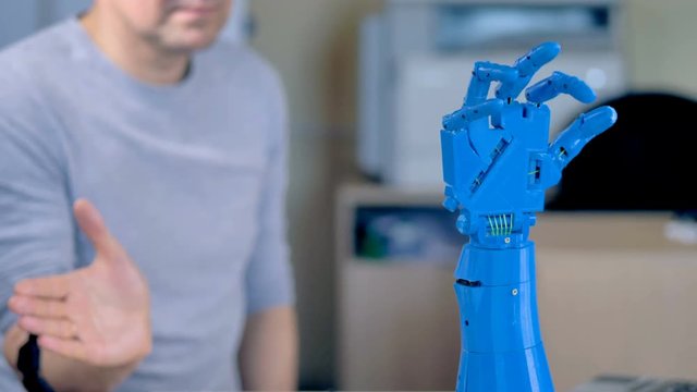 An engineer teaches a bionic arm to move.