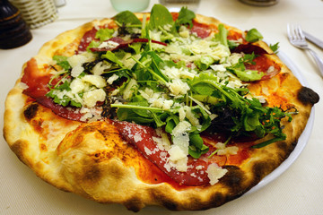 Italian pizza with fresh arugula on top