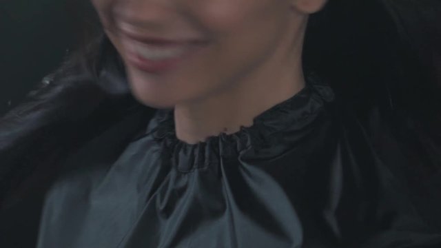 A girl in a peignoir moving hair.