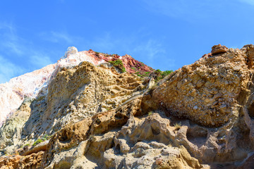 Huge colored rocks on Firiplaka Beach located on the south shore of the island of Milos. Cyclades Islands, Greece.