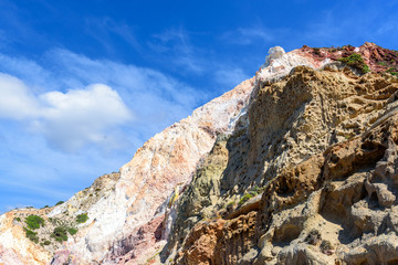 Huge colored rocks on Firiplaka Beach located on the south shore of the island of Milos. Cyclades Islands, Greece.
