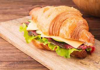 Sandwich with smoked salmon, cucumbers and cheese on the board, horizontal, selective focus, closeup