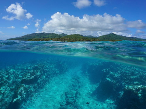 Over and under sea surface, South Pacific island and underwater the ocean floor on the fore reef eroded by the waves, Huahine, French Polynesia