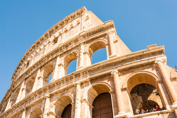 Obraz na płótnie Canvas ROME, ITALY - APRIL 24, 2017. Outside view of The Colosseum with tourists sightseeing.