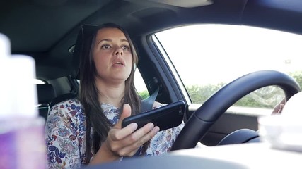 Woman texting message with cell phone while driving car getting distracted danger