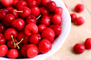 Healthy, juicy, fresh, organic cherries in fruit bowl close up. Cherries in background.