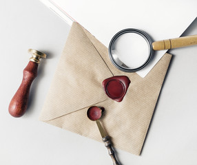 Vintage postal stationery. Photo of envelope, magnifier, seal, stamp and spoon on paper background....