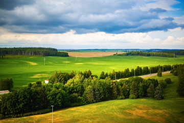 Naklejka premium Summer landscape with green meadows, fields, trees and forests. Minsk region, Belarus.