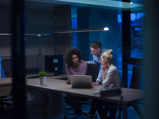 Multiethnic startup business team in night office