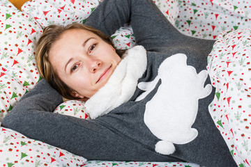 Obraz premium Happy girl resting in bed