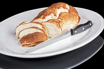 Fresh loaf of bread with a cutting knife