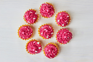 Pink cupcakes decorated with pearls and hearts