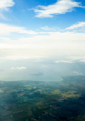 Aerial view from aircraft taken over Belgium showing landscape and cloud.