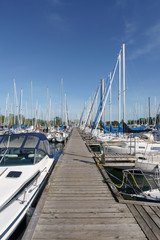 Fototapeta premium Stationary sailing boats alongside a pier, Toronto, Ontario, Canada, summer.