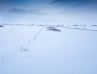 Deep snow covered landscape and hill in distance, Iceland, Europe.