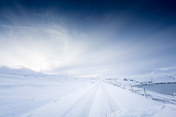 Deep snow covered road and landscape by day, Iceland, Europe.