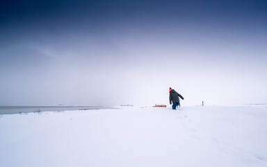 Young boy playing in deep snow covered landscape, Iceland, Europe.