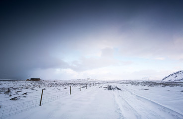 Cosy log cabin in snow covered landscape, distant, Iceland, Europe.