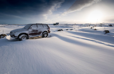 Fototapeta na wymiar Stationary car on snow covered landscape, high angle view, Iceland, Europe.