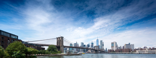 Panoramic view of city skyline and Brooklyn Bridge, New York City, USA.