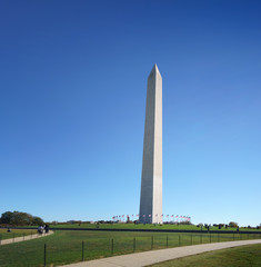 Obraz premium Distant view of Washington obelisk encircled with flags, Washington DC, USA.