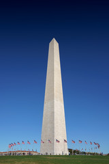 Distant view of Washington obelisk encircled with flags, Washington DC, USA.