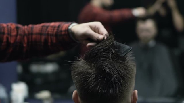 Barber Cuts the Hair in the Barbershop. Slow Motion