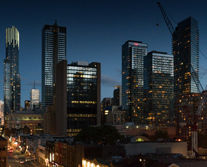 Fototapeta na wymiar Cityscape at dusk, modern skyscrapers with illuminated windows and Ontario, Canada.