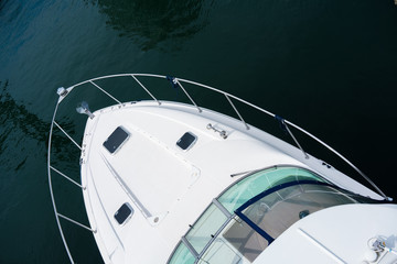 Luxury yacht on water in daytime elevated view showing front of yacht