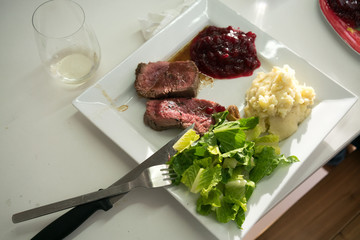 Steak on plate with cabbage and mashed potato, elevated view, close-up.
