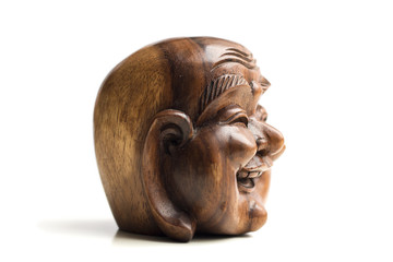 Wooden happy Buddha head statue. Souvenir from Indonesia, Southeast Asia. White background.