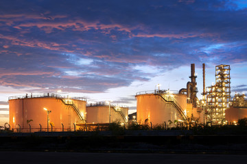 Industrial oil tanks in a refinery at twilight