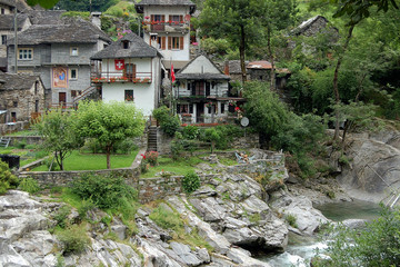 Fototapeta na wymiar Stone houses and green gardens of Lavertezzo next to the Verzasca river - Switzerland