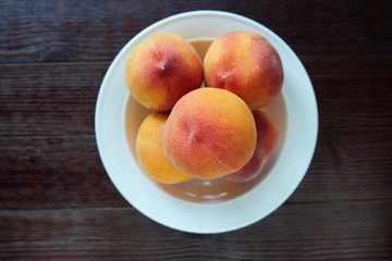 Plate with fresh juicy peaches 