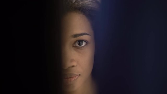 Woman eye watching through door slot. 4K